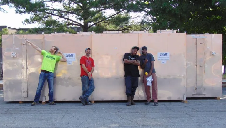 Four men in front of PureAir systems outside